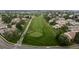 An aerial view displays a well-groomed golf course, surrounded by homes and tree-lined streets in a tranquil community at 8738 Chase Dr # 134, Arvada, CO 80003