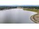 High angle view of lake and jogging path lined with lush vegetation with neighborhoods in the distance at 8738 Chase Dr # 134, Arvada, CO 80003