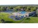 Aerial view showcasing the community amenities, including a pool, playground, and tennis courts at 8738 Chase Dr # 134, Arvada, CO 80003