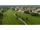 The aerial photo captures a beautifully kept golf course with vibrant greenery, interspersed with trees and paved walkways at 8738 Chase Dr # 134, Arvada, CO 80003