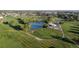 The aerial view highlights a beautiful golf course featuring lush green fairways, sand traps, and a serene pond at 8738 Chase Dr # 134, Arvada, CO 80003
