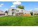 Spacious backyard showcasing a well-maintained lawn, a fenced in area, and a multi-level deck at 8738 Chase Dr # 134, Arvada, CO 80003