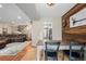 Open dining room featuring a unique wood accent wall, a table, and access to the living room at 8738 Chase Dr # 134, Arvada, CO 80003