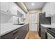 Efficient galley kitchen features white subway tiles and gray cabinets with stainless appliances at 8738 Chase Dr # 134, Arvada, CO 80003