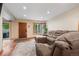 Cozy living room featuring hardwood floors, a comfy sectional couch, and lots of natural light at 8738 Chase Dr # 134, Arvada, CO 80003