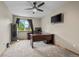 Functional office space with large desk, neutral carpet, and exterior view at 8738 Chase Dr # 134, Arvada, CO 80003