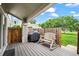 Covered back patio featuring a wooden rocking bench, grill and privacy fence at 8738 Chase Dr # 134, Arvada, CO 80003