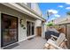 Back patio featuring a wooden rocking bench, grill and privacy fence next to sliding glass door at 8738 Chase Dr # 134, Arvada, CO 80003