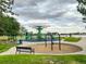 Vibrant playground area with various play structures, bench, and nearby lake views for Gathering fun at 8738 Chase Dr # 134, Arvada, CO 80003