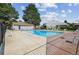 The community pool sparkles with clear blue water, surrounded by lounge chairs and well-maintained landscaping for relaxation at 8738 Chase Dr # 134, Arvada, CO 80003