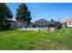 A community pool area with manicured green grass, surrounded by lounge chairs and a secure fence for safe enjoyment at 8738 Chase Dr # 134, Arvada, CO 80003