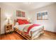 Comfortable bedroom with a rustic wood bed frame and view of the outdoors at 23778 Inca Rd, Indian Hills, CO 80454