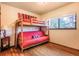 bedroom with a bunk bed, wood floors, and a window view at 23778 Inca Rd, Indian Hills, CO 80454