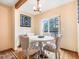 Cozy dining area with stylish upholstered chairs and natural light from large windows at 23778 Inca Rd, Indian Hills, CO 80454
