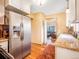 Open concept kitchen with stainless steel appliances, wood floors and views of the living room at 23778 Inca Rd, Indian Hills, CO 80454