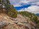 Beautiful landscape with mature trees, natural rock outcroppings and views for miles at 23778 Inca Rd, Indian Hills, CO 80454