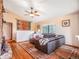 Bright living room with hardwood floors, a cozy sofa, and a large window with a picturesque outdoor view at 23778 Inca Rd, Indian Hills, CO 80454