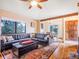 Comfortable living room showcasing a leather sectional sofa and hardwood floors at 23778 Inca Rd, Indian Hills, CO 80454