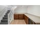 Finished basement with a kitchenette area featuring custom cabinets and a wine cooler at 4130 Umatilla St, Denver, CO 80211