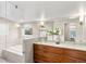 Modern bathroom with double vanity, sleek fixtures, large mirror, and luxurious tub at 4130 Umatilla St, Denver, CO 80211