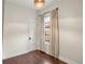 A calming bedroom features hardwood floors, a door, and a bright window at 4130 Umatilla St, Denver, CO 80211