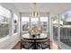 Sunny breakfast nook with large windows, a round table, and a view of the backyard at 4130 Umatilla St, Denver, CO 80211
