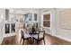 Elegant dining area showcasing hardwood floors, natural light, and open access to the kitchen at 4130 Umatilla St, Denver, CO 80211