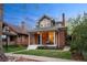 Charming two-story brick home with a covered front porch and well-maintained lawn and walkway at 4130 Umatilla St, Denver, CO 80211