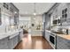 Well-equipped kitchen featuring modern appliances, gray cabinetry, and hardwood floors at 4130 Umatilla St, Denver, CO 80211