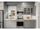 Contemporary kitchen with stainless steel appliances, gray cabinets, and white tile backsplash at 4130 Umatilla St, Denver, CO 80211