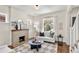 Cozy living room featuring a fireplace, modern decor, and hardwood floors with natural light at 4130 Umatilla St, Denver, CO 80211