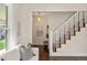 Inviting living room showcasing open staircase, hardwood floors, and plenty of natural light at 4130 Umatilla St, Denver, CO 80211