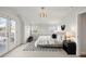 Stylish main bedroom with a private balcony, modern lighting, and soft carpet at 4130 Umatilla St, Denver, CO 80211