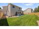 Expansive backyard featuring a well-maintained lawn, patio seating, and a privacy fence, ideal for outdoor activities at 15157 E Nassau Ave, Aurora, CO 80014
