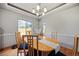 Elegant dining room featuring a wooden table, chairs, and a decorative chandelier at 15157 E Nassau Ave, Aurora, CO 80014