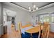 Elegant dining room featuring a wooden table, chairs, and crown molding at 15157 E Nassau Ave, Aurora, CO 80014