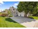 Beautiful home with an attached two-car garage, a well-manicured lawn, and shade trees at 15157 E Nassau Ave, Aurora, CO 80014