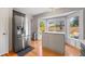 Bright kitchen features stainless steel refrigerator and breakfast nook with backyard views through bay windows at 15157 E Nassau Ave, Aurora, CO 80014