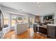 Updated kitchen featuring stainless appliances, an island cooktop, and nook with backyard views at 15157 E Nassau Ave, Aurora, CO 80014