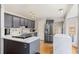 Contemporary kitchen featuring stainless steel appliances, a center island, and white stone countertops at 15157 E Nassau Ave, Aurora, CO 80014