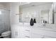 Modern bathroom featuring double sinks, sleek cabinetry, and glass-enclosed shower, providing a clean and contemporary look at 8 Oneida Ct, Denver, CO 80230