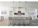 Bright, white kitchen featuring an island with bar seating and stylish pendant lighting at 8 Oneida Ct, Denver, CO 80230