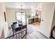 Open dining area with a stylish table, modern lighting, and access to the backyard at 1488 S Biscay Ct, Aurora, CO 80017