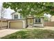 Inviting two-story home with an attached garage and a vibrant green lawn at 1488 S Biscay Ct, Aurora, CO 80017