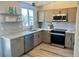 Charming kitchen boasts modern appliances, light wood cabinets, and bright countertops at 1488 S Biscay Ct, Aurora, CO 80017