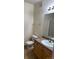 Well-maintained bathroom featuring a vanity, toilet, and a large mirror at 8520 S Holland Ln # 302, Littleton, CO 80128