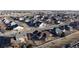 Aerial view of homes with fenced yards in a suburban neighborhood surrounded by open spaces at 1724 Silverado Ln, Fort Lupton, CO 80621