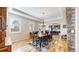 Elegant dining room featuring hardwood floors, stylish furniture, and an arched entrance to the kitchen at 1724 Silverado Ln, Fort Lupton, CO 80621