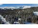 Aerial view of a log home in a winter mountain setting at 229 Lee Ln, Breckenridge, CO 80424