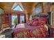 Spacious main bedroom with a large bed, abundant natural light, and wooden beams at 229 Lee Ln, Breckenridge, CO 80424